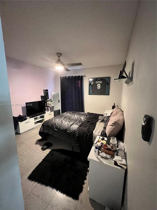 Tile flooring and ceiling-mounted light fixture with integrated fan
