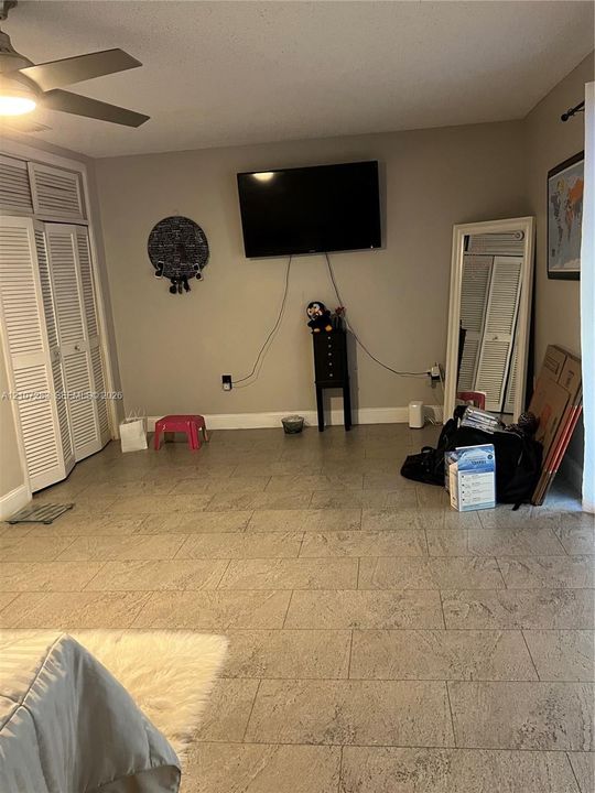 Tile flooring, ceiling fan, and louvered closet doors