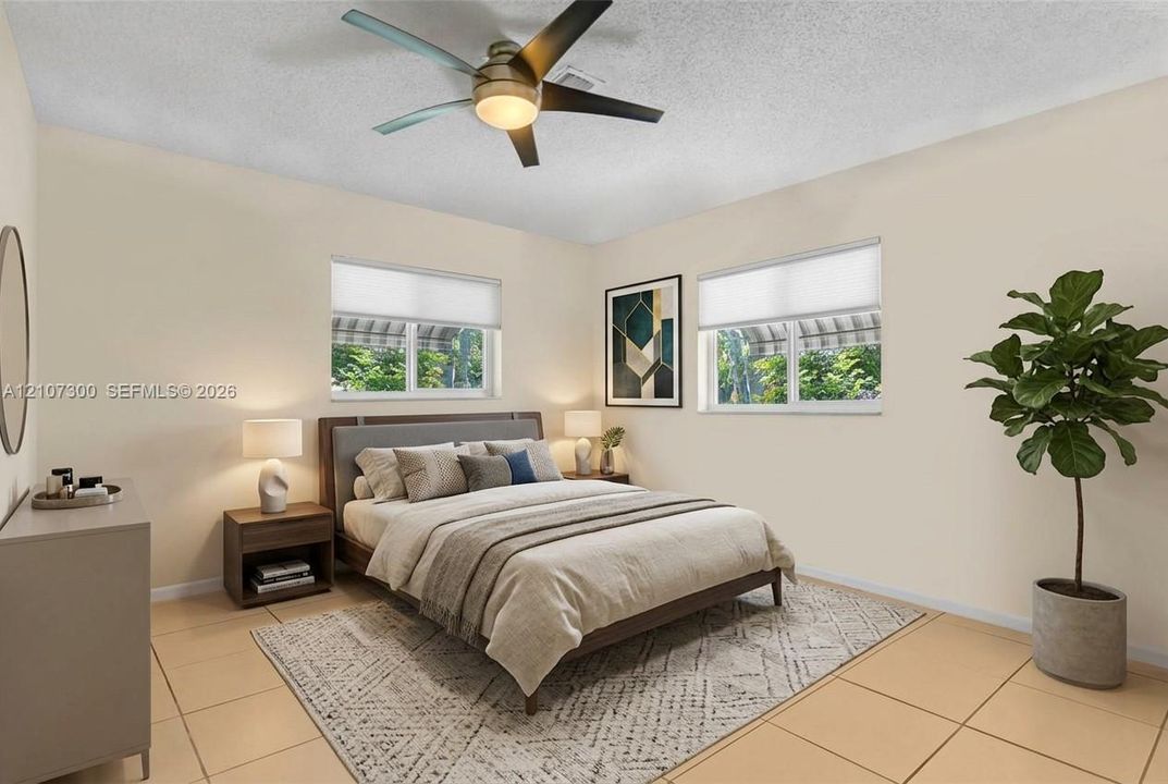 Neutral-toned interior featuring large-format floor tiles, dual windows with fitted shades, and a ceiling fan with integrated lighting