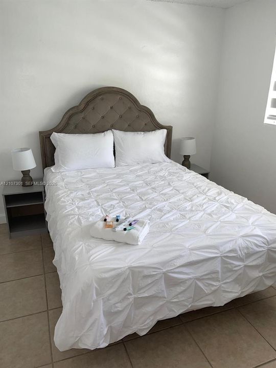 Neutral wall finish with large-format tile flooring and natural light entry
