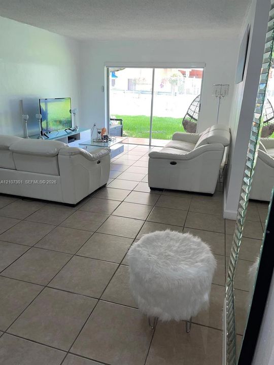 Ceramic tile flooring, sliding glass door, and interior wall finishes