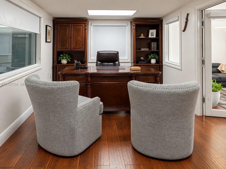 Built-in stained wood cabinetry with integrated shelving, wood-finish flooring, and a recessed ceiling skylight