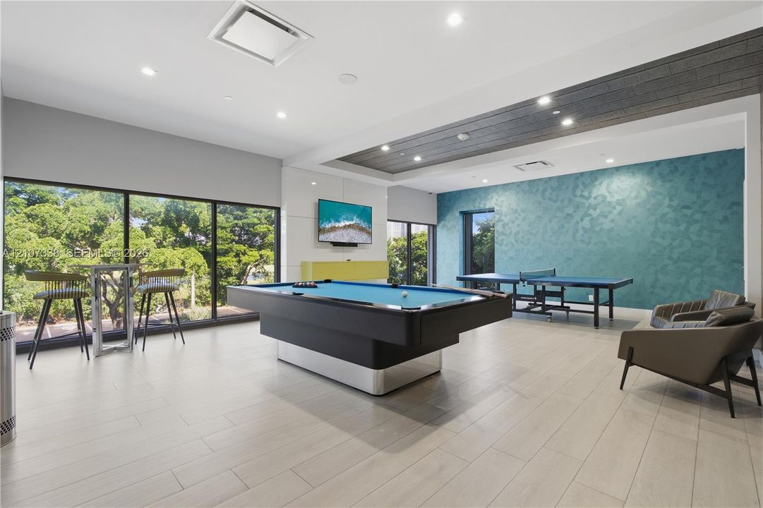 Recreation room featuring floor-to-ceiling windows, wood-finish flooring, recessed lighting, and a coffered ceiling with wood-plank detailing