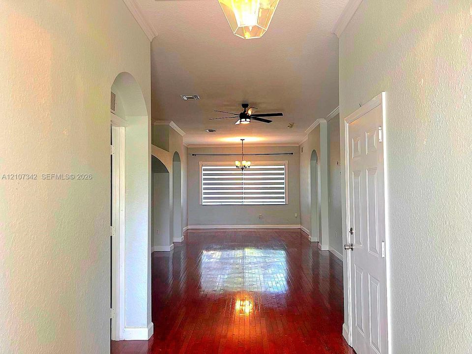 Entryway featuring wood-finish flooring, vaulted ceilings with arched architectural detailing, and recessed lighting
