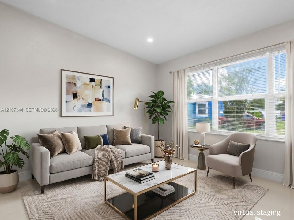 Neutral wall palette with a large multi-pane window featuring horizontal blinds and recessed ceiling lighting