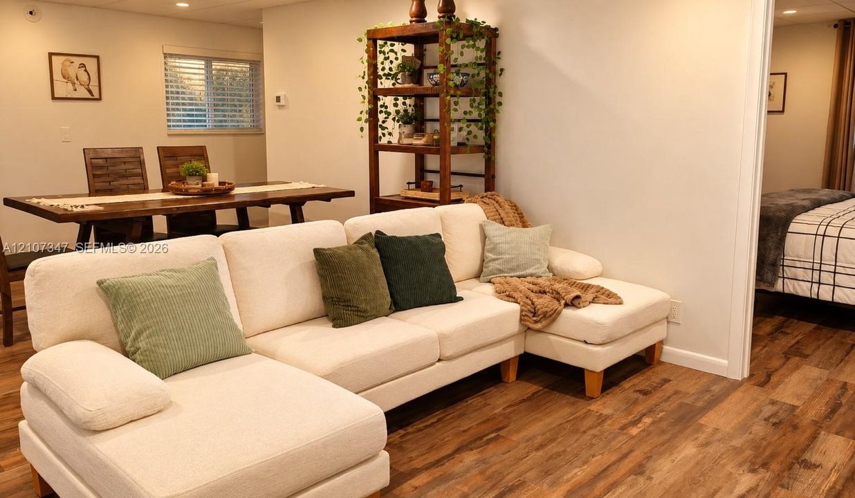 Wood-finish flooring, recessed lighting, and white interior wall paint