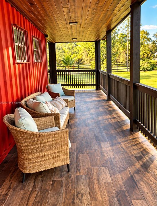 Covered porch featuring wood-finish plank flooring, stained wood ceiling, corrugated metal exterior siding, and custom balustrade railing