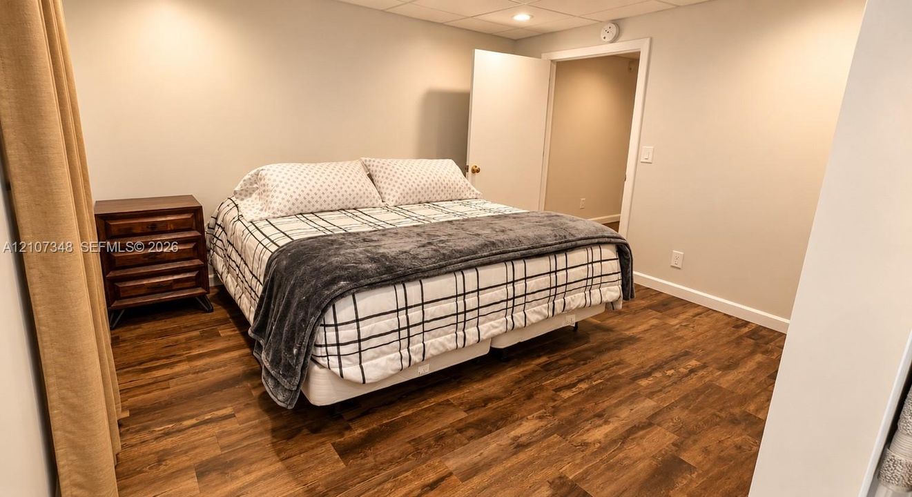 Wood-finish flooring, neutral wall tones, and recessed lighting