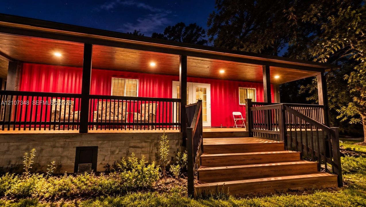 Covered porch featuring a natural wood-finish ceiling, recessed lighting, black metal railing, and wide wooden steps