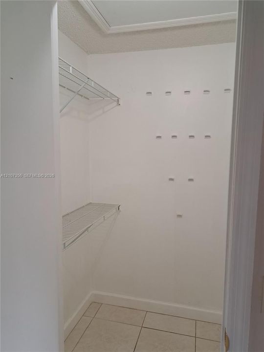 Walk in closet in Master Bedroom featuring tile flooring and multi-level wire shelving