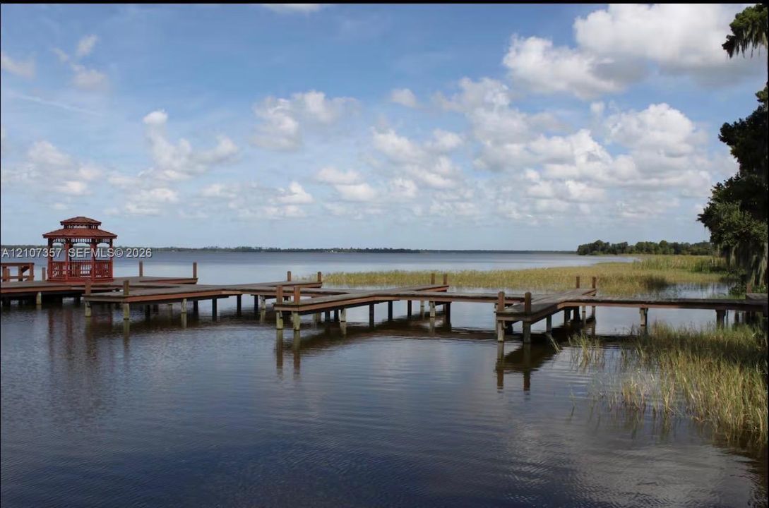Waterfront property featuring a multi-slip wooden dock and a covered gazebo