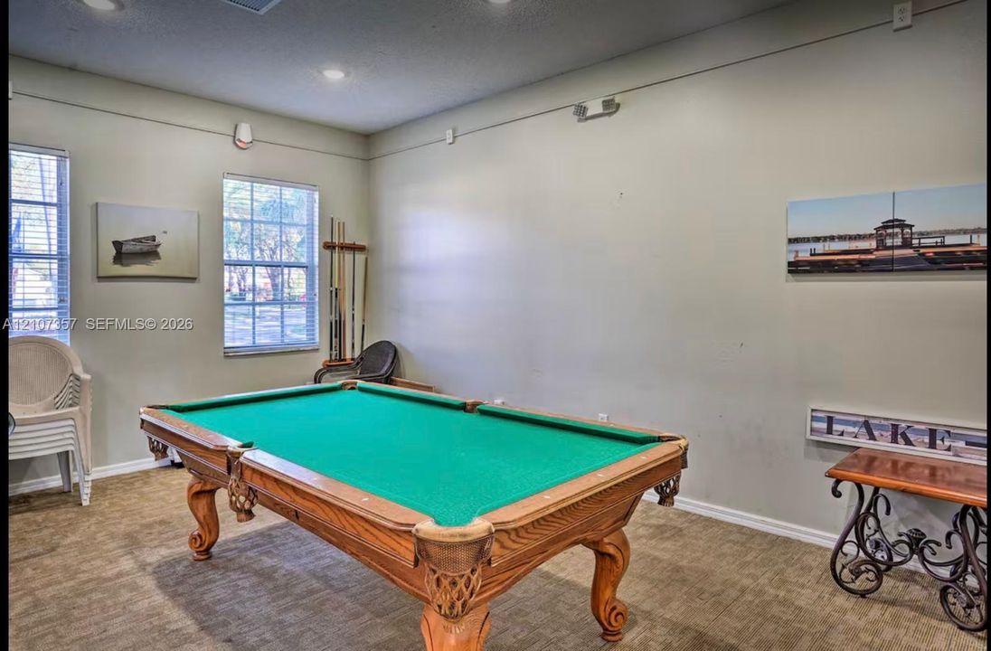 Interior room featuring recessed lighting, neutral wall paint, and multiple double-hung windows