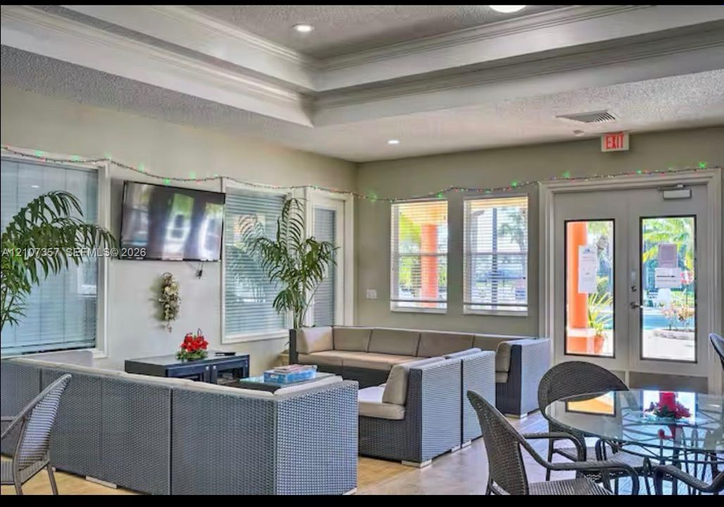 Tray ceiling with recessed lighting, oversized windows with integrated blinds, and dual-glass pane doors