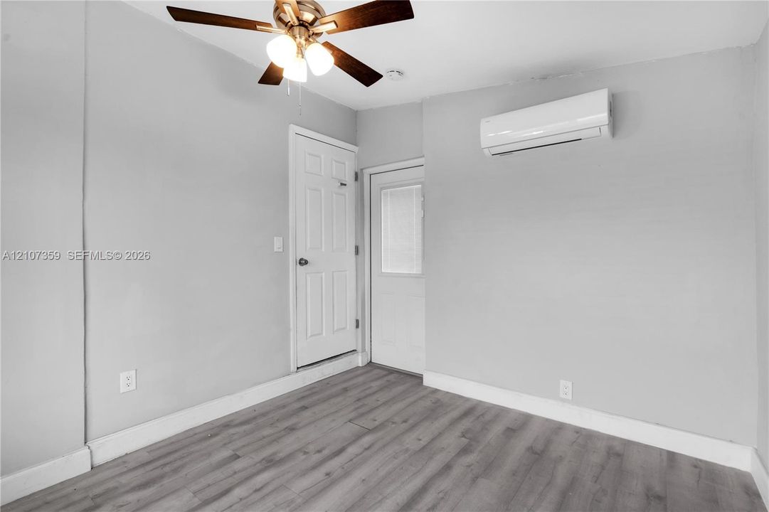 Bedroom featuring a mini-split A/C unit and ceiling fan.