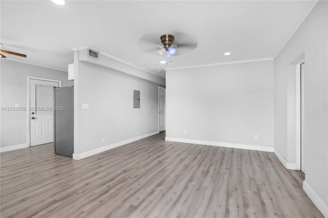 Actual living room with updated flooring, natural light, and recessed lighting