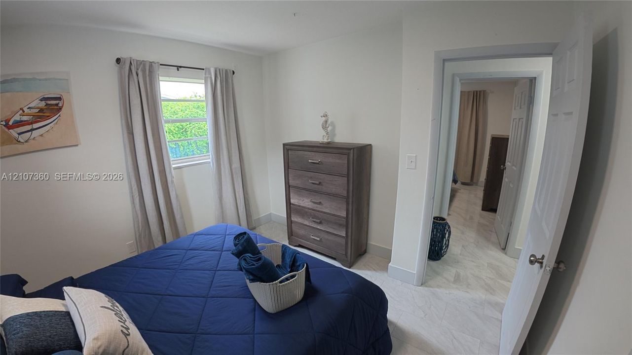 Neutral wall palette featuring light-toned tile flooring and a single-hung window