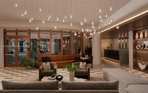 Expansive lobby featuring a custom spherical pendant lighting installation, geometric tile flooring, floor-to-ceiling glass-paneled walls with wood framing, and built-in recessed shelving with integrated lighting
