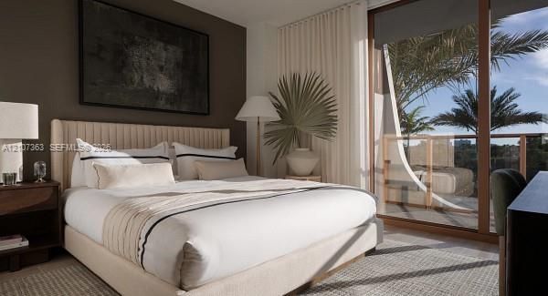 Floor-to-ceiling glass sliding doors, private balcony, wood-finish framing, accent wall, and stone-finish flooring