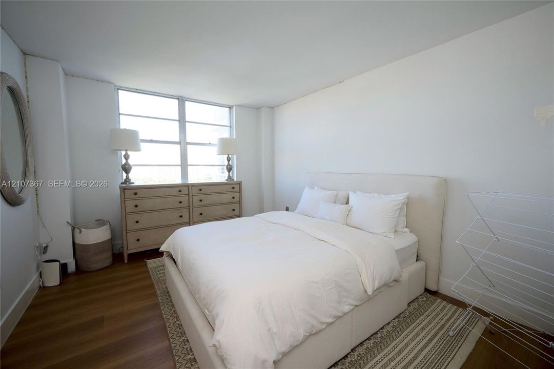 Room featuring wood-finish flooring and large multi-pane windows