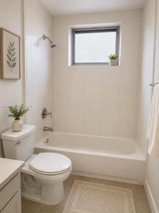 Bathroom featuring a porcelain tub and shower combination with chrome fixtures, floor-to-ceiling ceramic wall tile, and an operable window