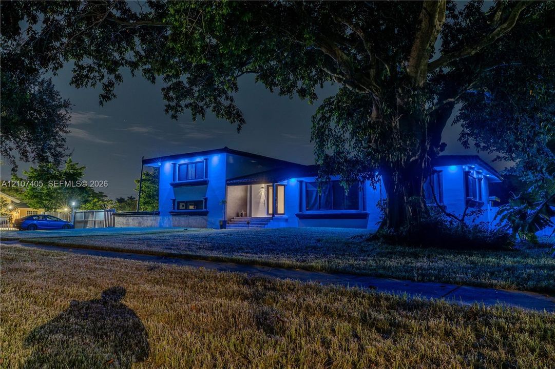 Exterior deck featuring durable composite decking, integrated wall-mounted exterior lighting, and stucco siding