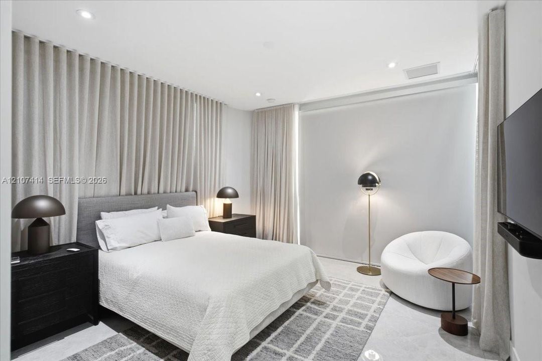 Wall-to-wall floor-to-ceiling drapery, recessed ceiling lighting, and smooth surface flooring