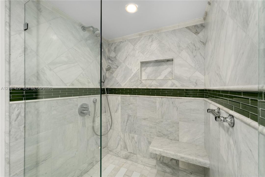Bathroom featuring dual vessel sinks, stone-patterned vanity countertop, full-height wall mirrors, and recessed ceiling lighting