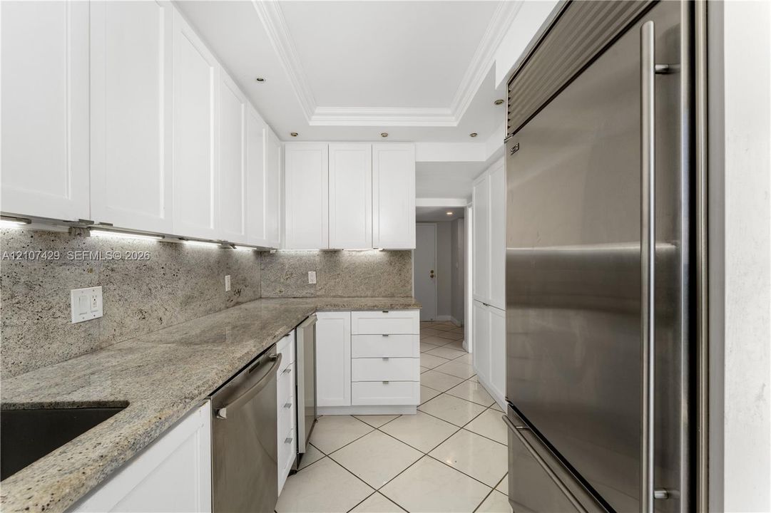Floor-to-ceiling windows, white tile flooring, ceiling fan, and crown molding