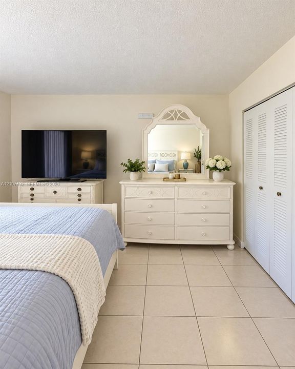 Neutral ceramic floor tile and white louvered bifold closet doors