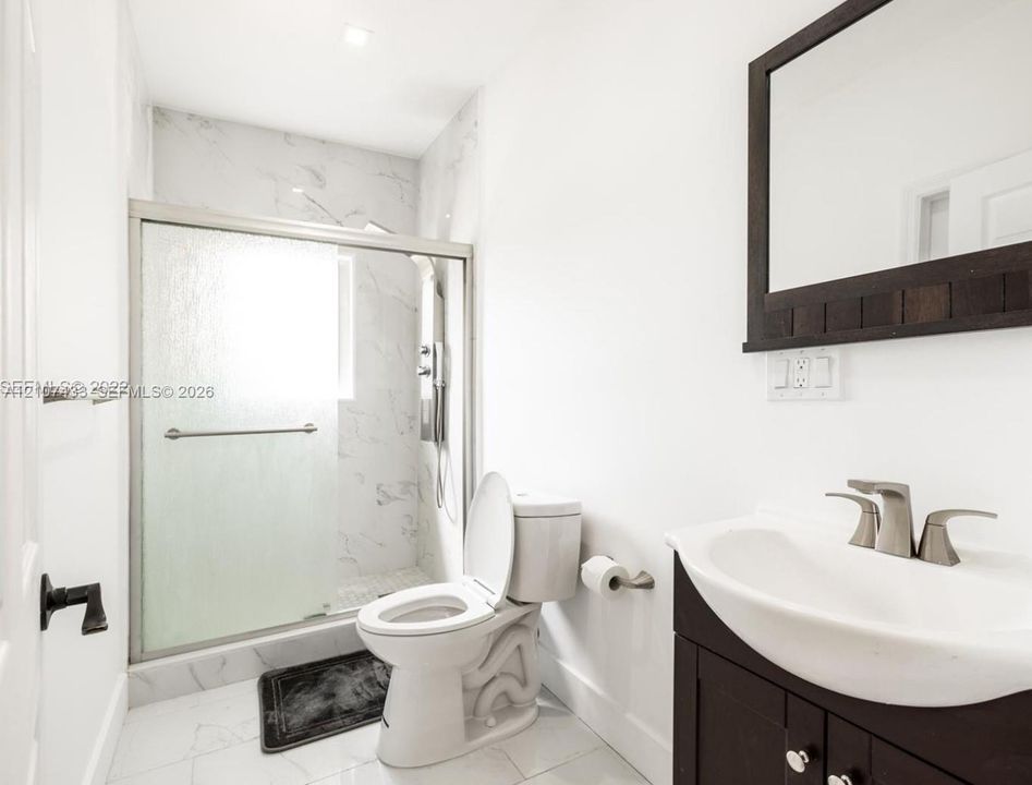 Wood-finish flooring, white louvered closet doors, recessed lighting, and a single-hung window