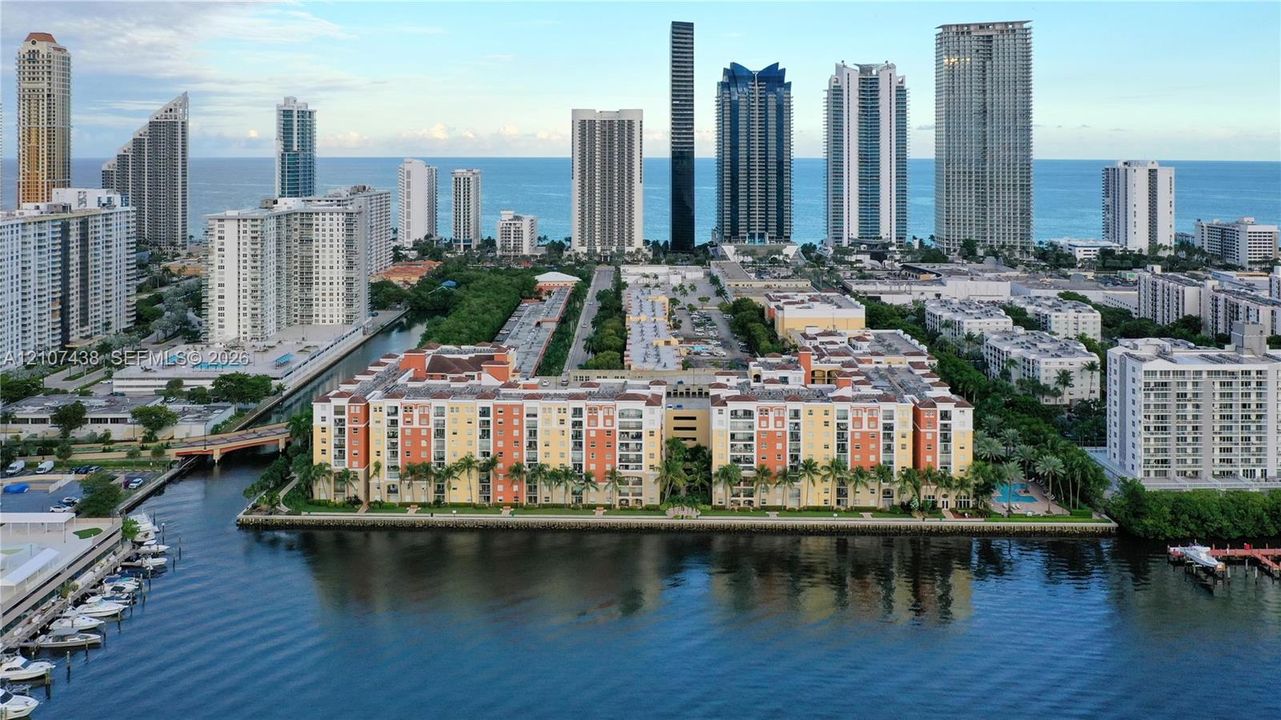 Waterfront multi-story residential complex featuring landscaped grounds and immediate access to canal frontage