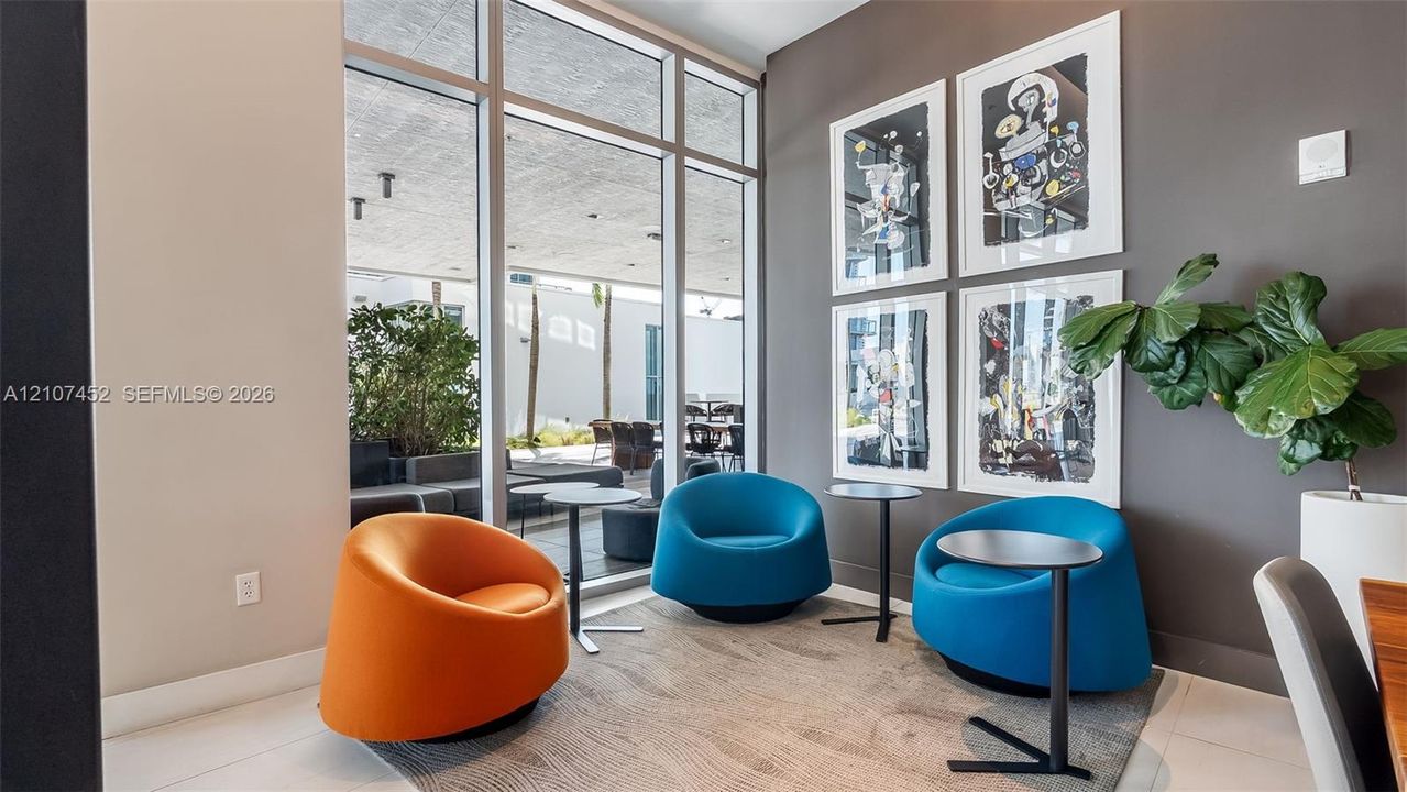 Floor-to-ceiling windows featuring expansive structural glass panels and neutral-toned wall finish