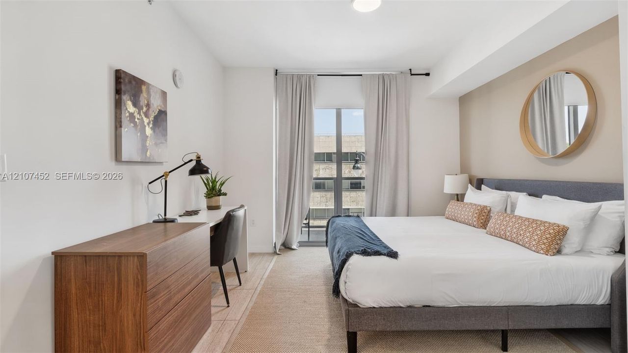 Room featuring neutral paint tones, an accent wall, carpeted flooring, and a glass-paneled door