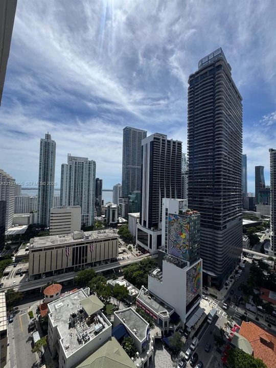 High-rise cityscape featuring panoramic urban density, multiple glass-facade skyscrapers, and infrastructure corridors