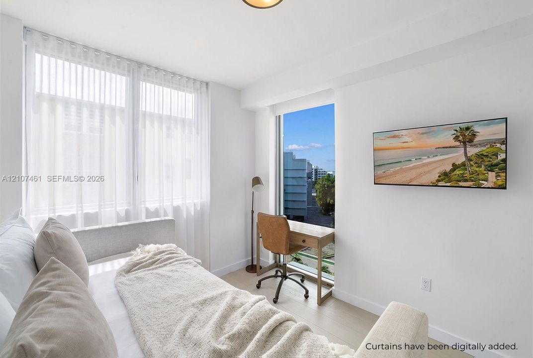 Bright interior featuring large floor-to-ceiling windows, light-toned wood-finish flooring, and crisp white walls