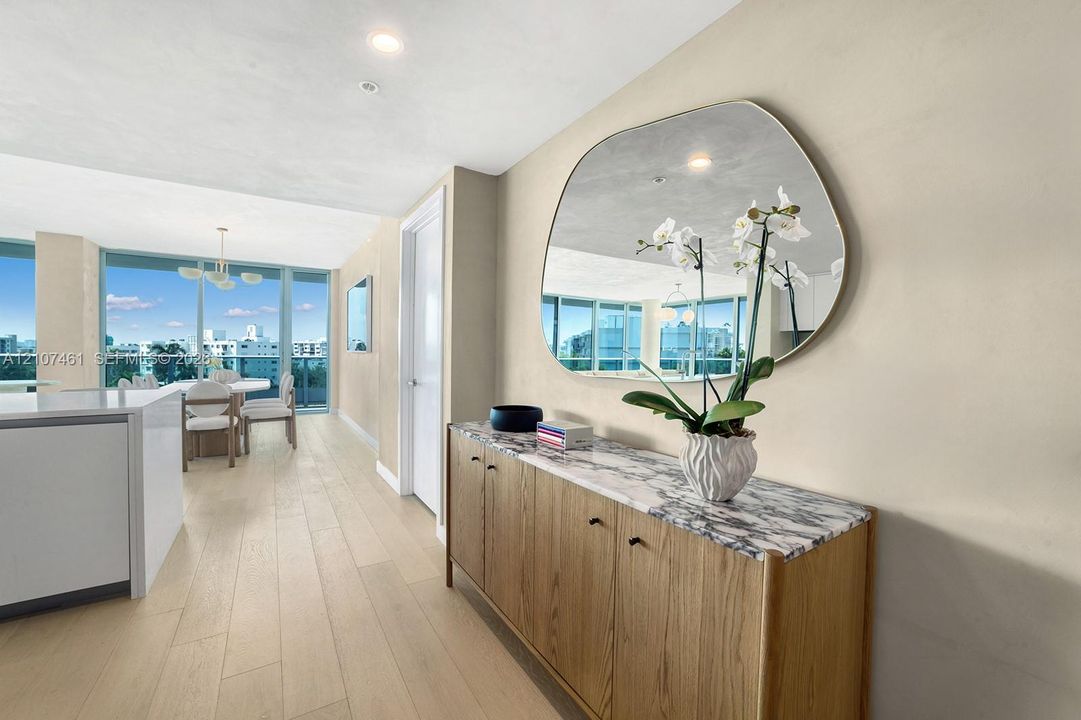 Light-toned wood-finish flooring, floor-to-ceiling windows, and recessed lighting