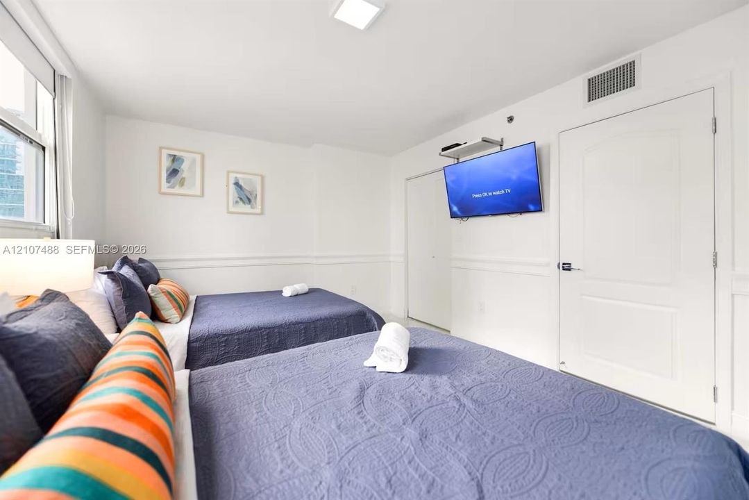 Bright room featuring chair rail molding, crisp white walls, and a recessed ceiling light