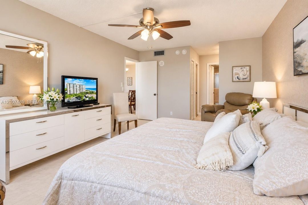 Bedroom featuring neutral wall paint, tile flooring, and a ceiling fan with integrated lighting