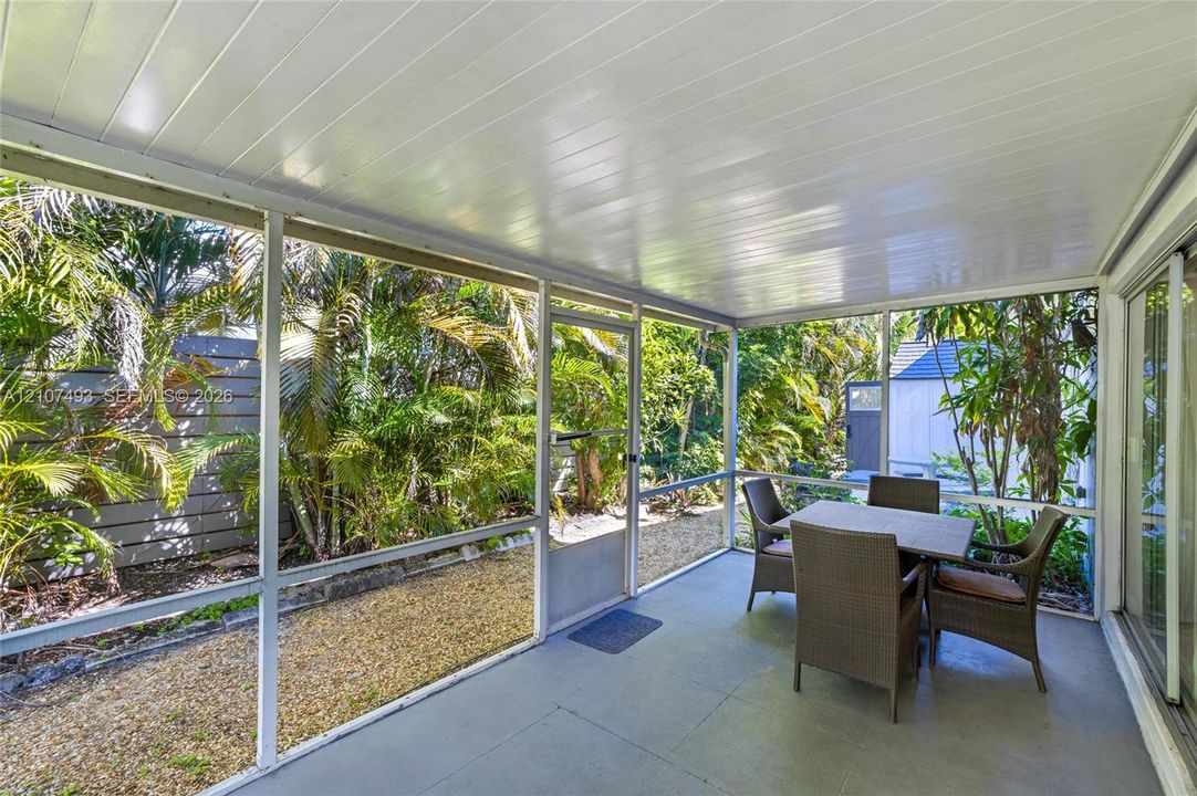 Main Apt, West side, Screened-in porch featuring a painted concrete floor, a board ceiling, and full-height mesh screening