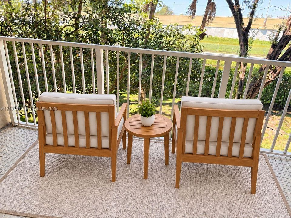 Private balcony featuring a white metal railing and square tile flooring