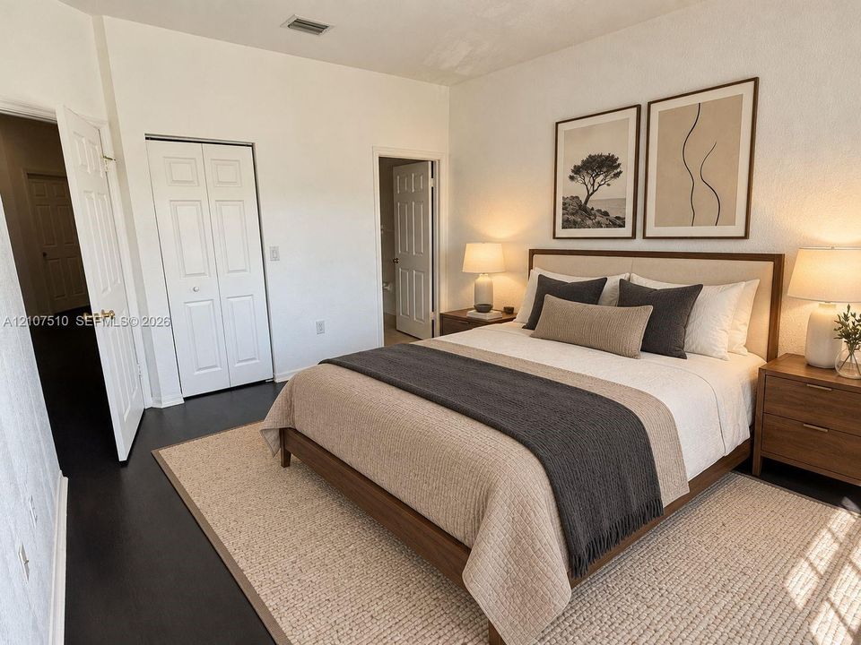 Room featuring dark wood-finish flooring, white walls, and a bi-fold closet door