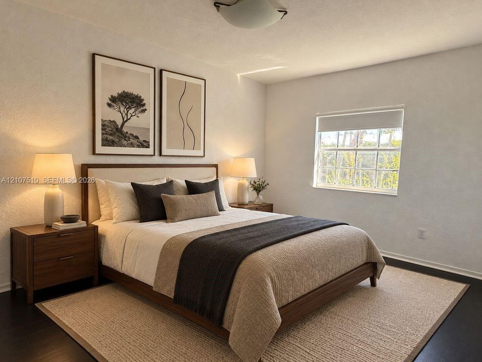 Spacious room featuring dark-toned flooring, neutral walls, and a window with a built-in shade