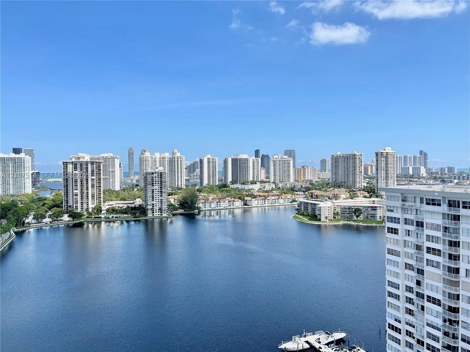 Elevated perspective featuring a expansive waterway, coastal skyline, and nautical docks