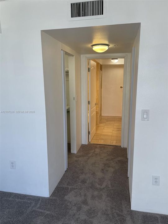 Neutral wall paint, plush carpeting, ceiling-mounted flush lighting, and tiled flooring