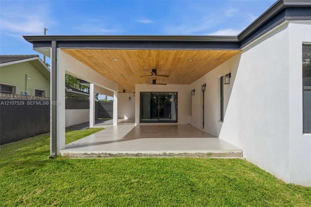 Finished garage space featuring hexagonal LED ceiling panels, smooth white walls, and a painted concrete floor