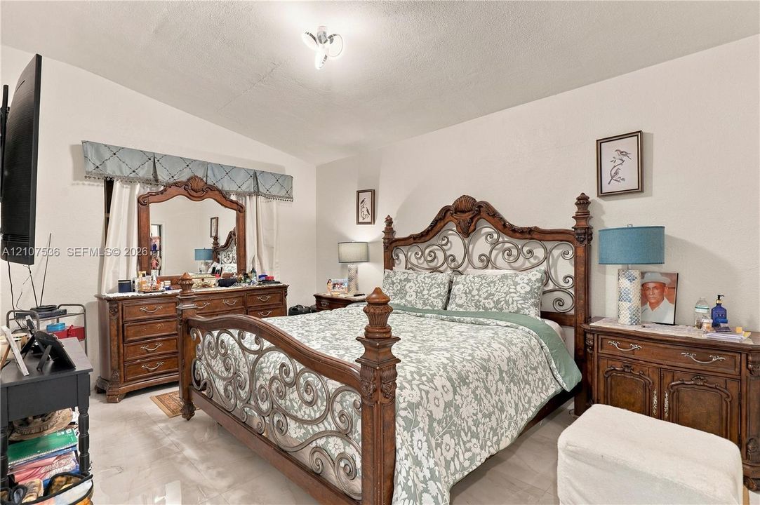 Room featuring neutral wall finishes, tile flooring, and a multi-arm flush-mount ceiling light fixture
