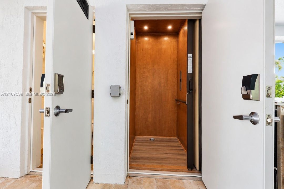 Private elevator featuring wood-paneled walls, recessed ceiling lighting, and wood-finish flooring