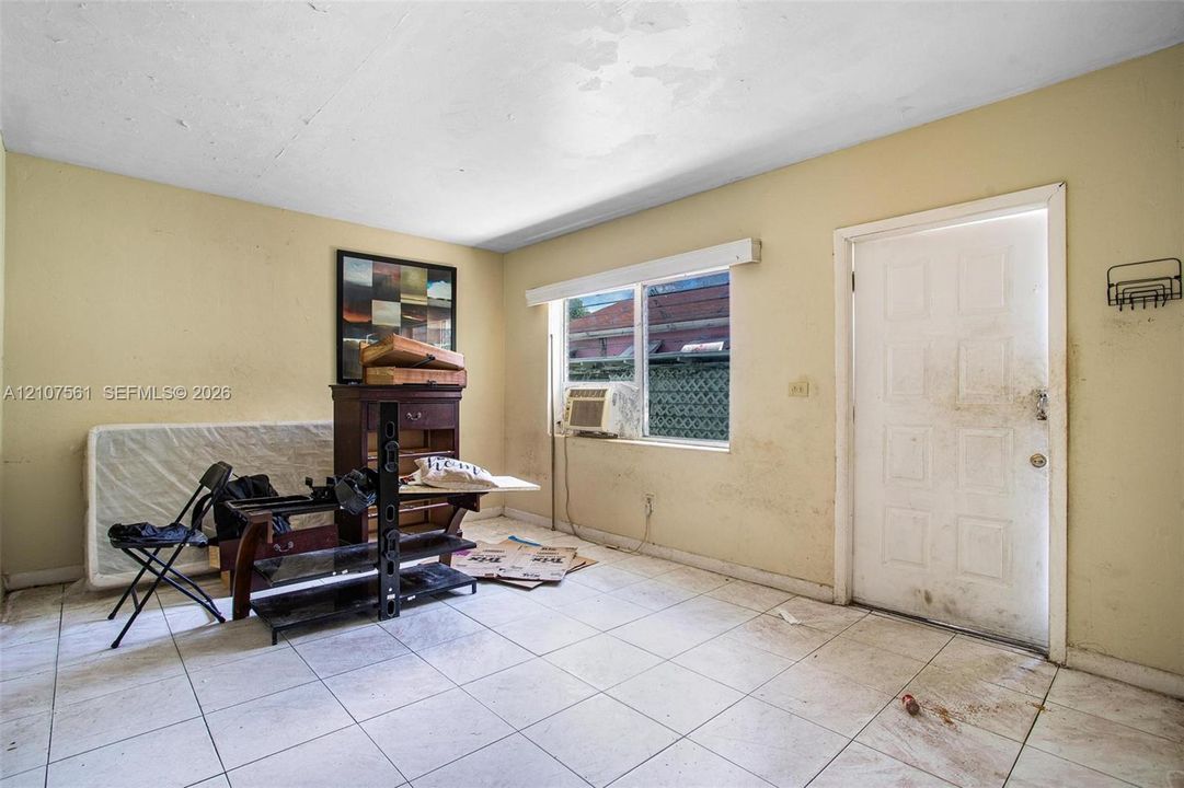 Interior space featuring white square tile flooring and a multi-panel exterior door