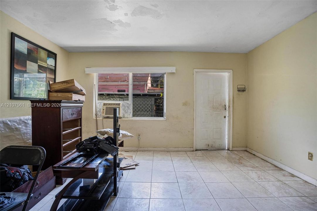 Interior room featuring tile flooring and a multi-pane window