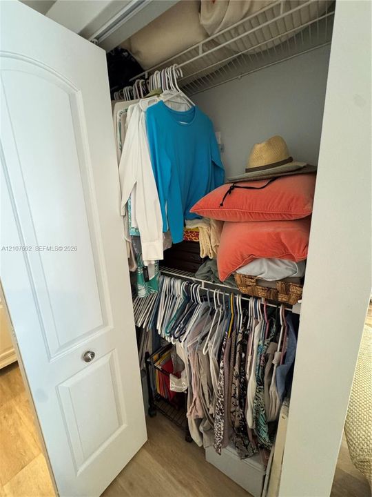 Storage closet featuring a two-panel interior door with brushed metal hardware and multi-level wire shelving